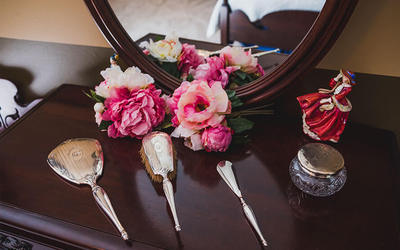 brushes and flowers on a dresser